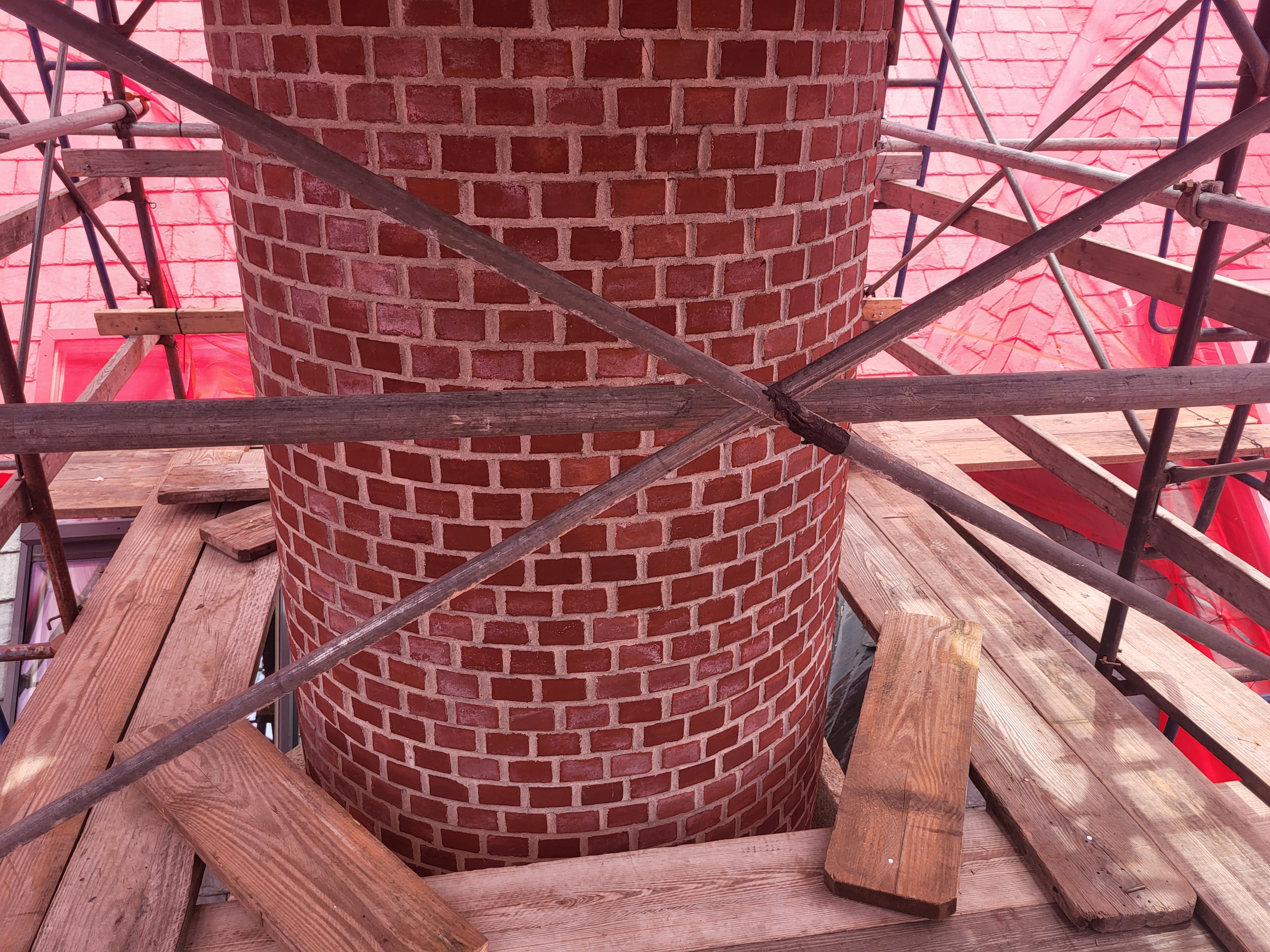 Roof view of chimney requiring repairs due to cracking